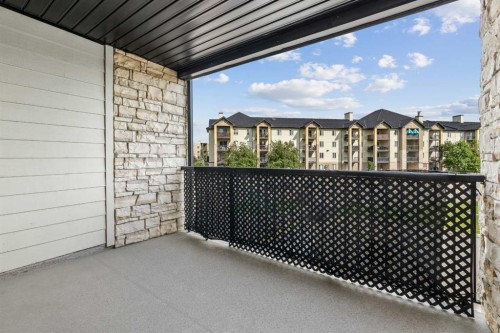 7207-304 Mackenzie Way Sw, Airdrie, AB - Outdoor With Deck Patio Veranda With Exterior