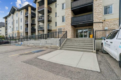 7207-304 Mackenzie Way Sw, Airdrie, AB - Outdoor With Balcony With Facade