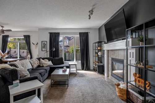 5 Copperpond Link Se, Calgary, AB - Indoor Photo Showing Living Room With Fireplace