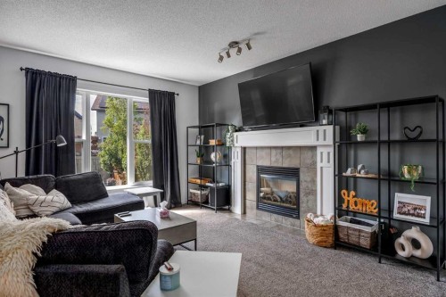 5 Copperpond Link Se, Calgary, AB - Indoor Photo Showing Living Room With Fireplace