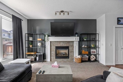 5 Copperpond Link Se, Calgary, AB - Indoor Photo Showing Living Room With Fireplace