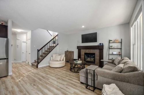 58 Copperstone Close Se, Calgary, AB - Indoor Photo Showing Living Room With Fireplace
