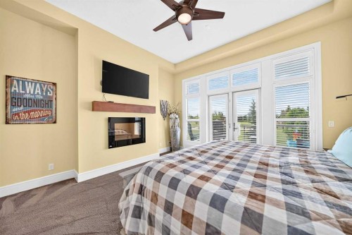 109 Waters Edge Drive, Heritage Pointe, AB - Indoor Photo Showing Bedroom With Fireplace