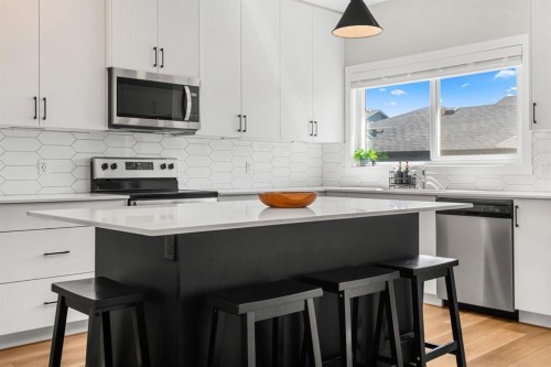 102 Midgrove Sw, Airdrie, AB - Indoor Photo Showing Kitchen With Stainless Steel Kitchen With Upgraded Kitchen