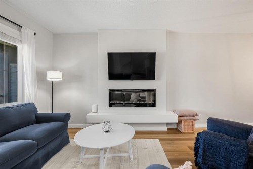 102 Midgrove Sw, Airdrie, AB - Indoor Photo Showing Living Room With Fireplace