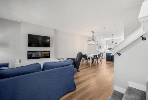 102 Midgrove Sw, Airdrie, AB - Indoor Photo Showing Living Room With Fireplace