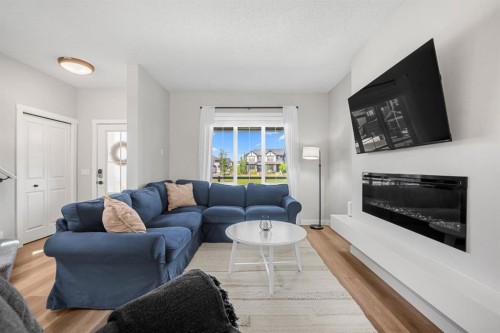 102 Midgrove Sw, Airdrie, AB - Indoor Photo Showing Living Room With Fireplace