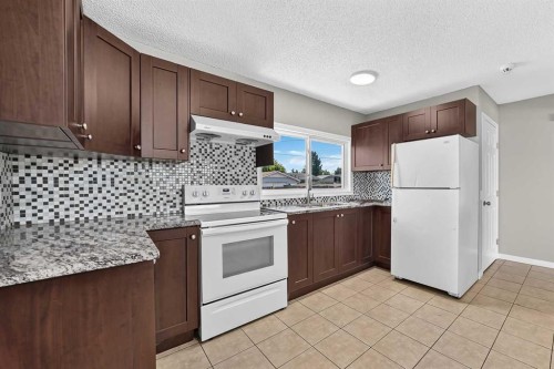 80 Pensville Road Se, Calgary, AB - Indoor Photo Showing Kitchen With Double Sink
