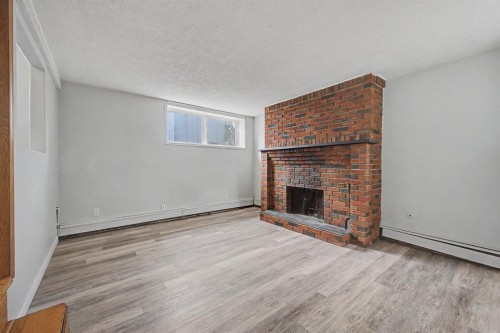 4004 79 Street Nw, Calgary, AB - Indoor Photo Showing Living Room With Fireplace