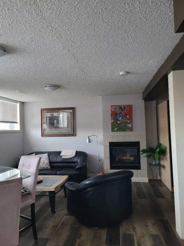 7539 Hunterview Drive Nw, Calgary, AB - Indoor Photo Showing Living Room With Fireplace