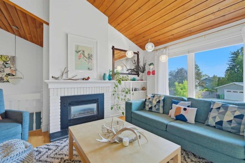 111 Coachwood Crescent Sw, Calgary, AB - Indoor Photo Showing Living Room With Fireplace