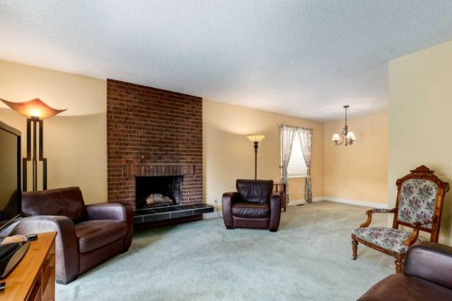 2512 106 Avenue Sw, Calgary, AB - Indoor Photo Showing Living Room With Fireplace