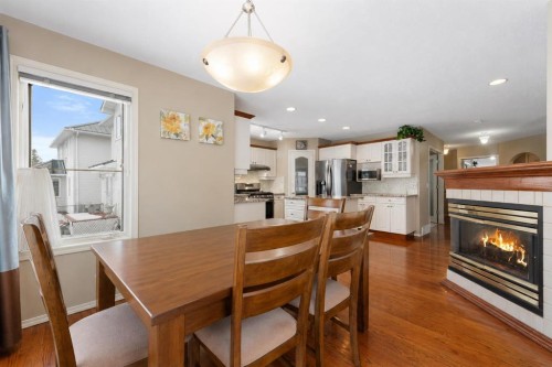 69 Hampstead Gardens Nw, Calgary, AB - Indoor Photo Showing Dining Room With Fireplace