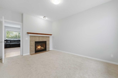 38 Silverado Skies Crescent Sw, Calgary, AB - Indoor Photo Showing Other Room With Fireplace
