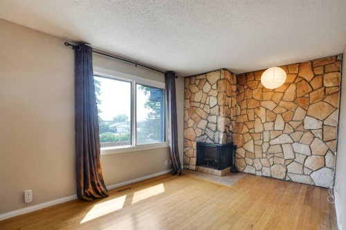 6-6404 4A Street Ne, Calgary, AB - Indoor Photo Showing Other Room With Fireplace