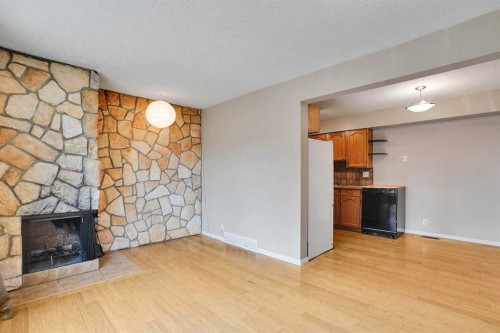 6-6404 4A Street Ne, Calgary, AB - Indoor Photo Showing Living Room With Fireplace