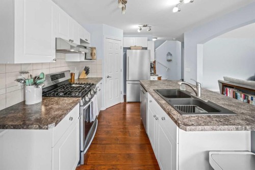43 Cougar Ridge Bay Sw, Calgary, AB - Indoor Photo Showing Kitchen With Stainless Steel Kitchen With Double Sink With Upgraded Kitchen