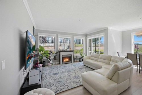 3137-1010 Arbour Lake Road Nw, Calgary, AB - Indoor Photo Showing Living Room With Fireplace