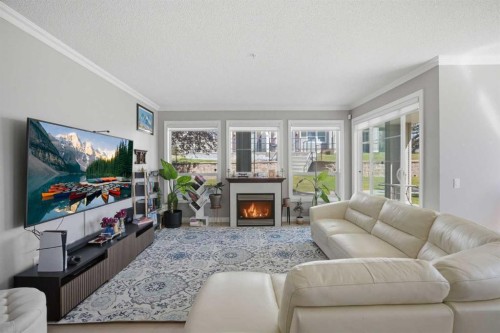 3137-1010 Arbour Lake Road Nw, Calgary, AB - Indoor Photo Showing Living Room With Fireplace