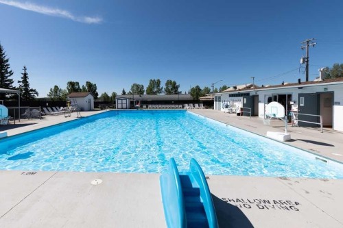 315 Willow Ridge Way, Diamond Valley, AB - Outdoor With In Ground Pool