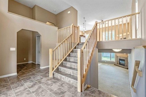 315 Willow Ridge Way, Diamond Valley, AB - Indoor Photo Showing Other Room With Fireplace