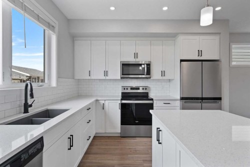 1006 Mahogany Boulevard Se, Calgary, AB - Indoor Photo Showing Kitchen With Stainless Steel Kitchen With Double Sink With Upgraded Kitchen