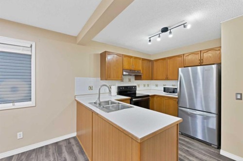 54 Martinridge Road Ne, Calgary, AB - Indoor Photo Showing Kitchen With Double Sink