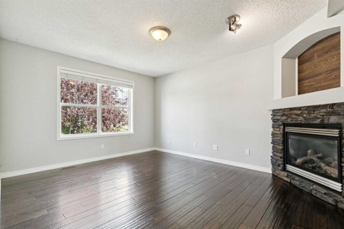 208 Everridge Way Sw, Calgary, AB - Indoor Photo Showing Living Room With Fireplace