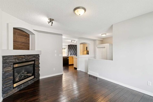 208 Everridge Way Sw, Calgary, AB - Indoor Photo Showing Living Room With Fireplace