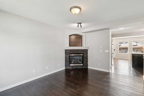 208 Everridge Way Sw, Calgary, AB - Indoor Photo Showing Living Room With Fireplace