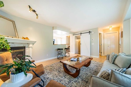 164 Somme Manor Sw, Calgary, AB - Indoor Photo Showing Living Room With Fireplace