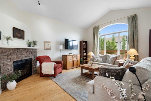 19 Rockmont Court Nw, Calgary, AB - Indoor Photo Showing Living Room With Fireplace