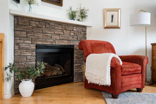 19 Rockmont Court Nw, Calgary, AB - Indoor Photo Showing Living Room With Fireplace
