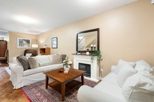 19 Rockmont Court Nw, Calgary, AB - Indoor Photo Showing Living Room With Fireplace