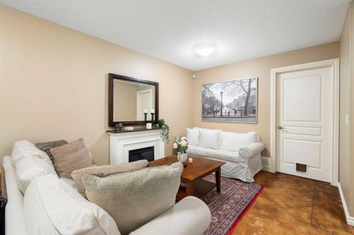 19 Rockmont Court Nw, Calgary, AB - Indoor Photo Showing Living Room With Fireplace