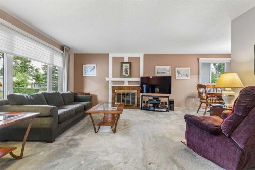 3131 Oakwood Drive Sw, Calgary, AB - Indoor Photo Showing Living Room With Fireplace