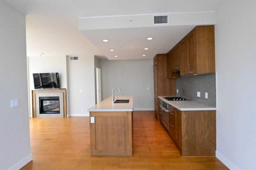 1615-222 Riverfront Avenue Sw, Calgary, AB - Indoor Photo Showing Kitchen With Fireplace