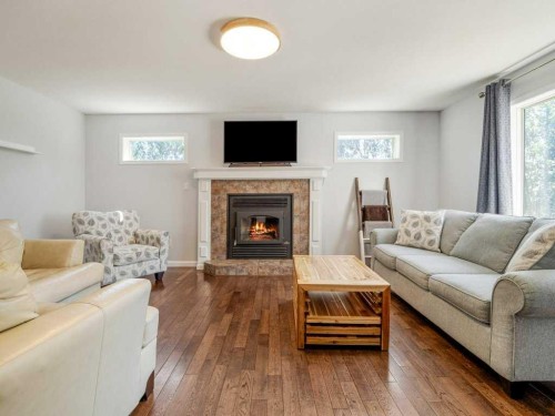 338 Deer Run Place West, Rural Lethbridge County, AB - Indoor Photo Showing Living Room With Fireplace