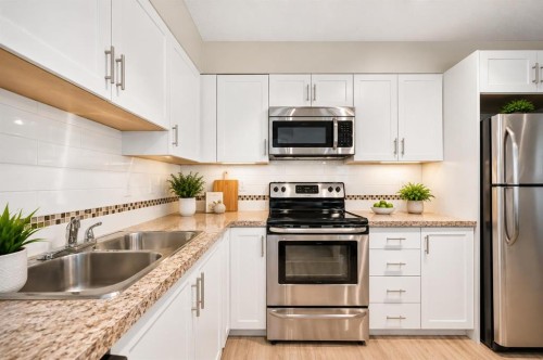 5210-279 Copperpond Common Se, Calgary, AB - Indoor Photo Showing Kitchen With Stainless Steel Kitchen With Double Sink With Upgraded Kitchen