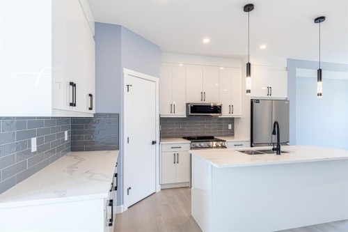 1995 Mccaskill Drive, Crossfield, AB - Indoor Photo Showing Kitchen With Double Sink With Upgraded Kitchen
