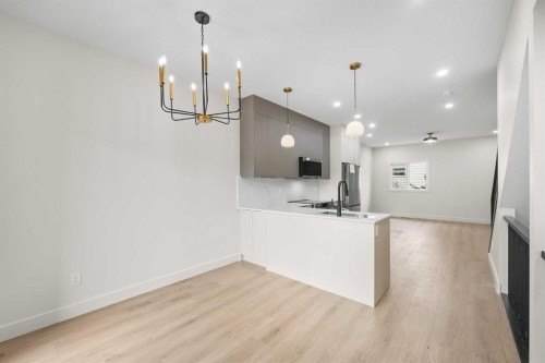 301-67 Panatella Square Nw, Calgary, AB - Indoor Photo Showing Kitchen With Double Sink
