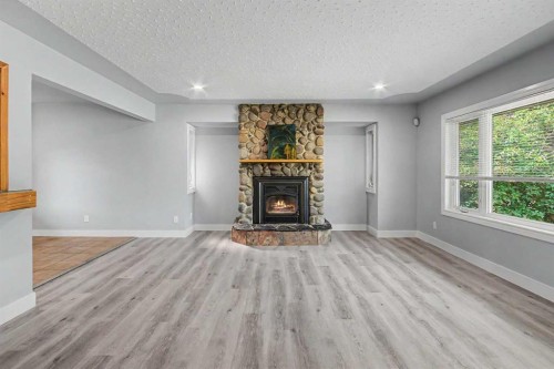 18 Collingwood Place Nw, Calgary, AB - Indoor Photo Showing Living Room With Fireplace