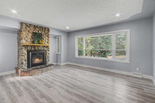 18 Collingwood Place Nw, Calgary, AB - Indoor Photo Showing Living Room With Fireplace