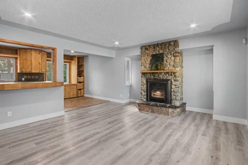 18 Collingwood Place Nw, Calgary, AB - Indoor Photo Showing Living Room With Fireplace