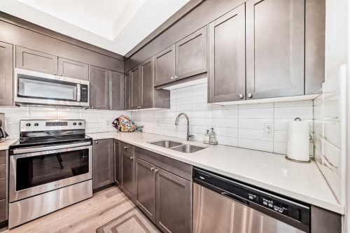 402-30 Shawnee Common Sw, Calgary, AB - Indoor Photo Showing Kitchen With Stainless Steel Kitchen With Double Sink With Upgraded Kitchen