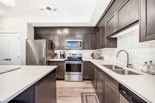 402-30 Shawnee Common Sw, Calgary, AB - Indoor Photo Showing Kitchen With Stainless Steel Kitchen With Double Sink With Upgraded Kitchen