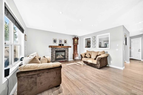 265 Bridleridge View Sw, Calgary, AB - Indoor Photo Showing Living Room With Fireplace