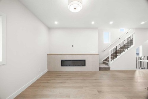 305-67 Panatella Square Nw, Calgary, AB - Indoor With Fireplace