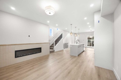 305-67 Panatella Square Nw, Calgary, AB - Indoor Photo Showing Other Room With Fireplace