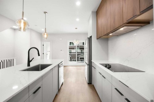305-67 Panatella Square Nw, Calgary, AB - Indoor Photo Showing Kitchen With Upgraded Kitchen